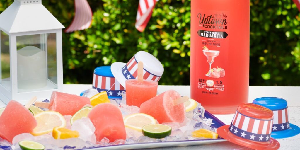 Strawberry popsicles with US flag party favors and Uptown Cocktails strawberry margarita