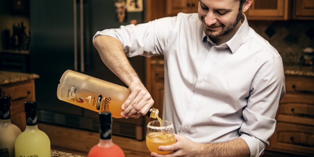 Man pouring Uptown Cocktails Mango Margarita