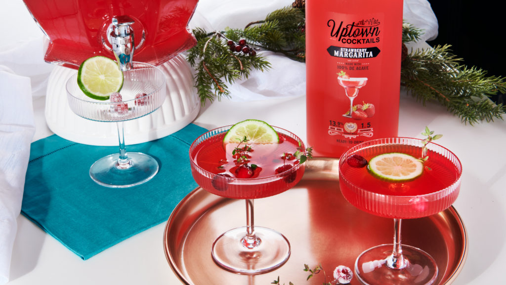 strawberry cran margaritas with uptown cocktails bottle and holiday decor